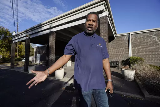 Otis Wells, 51, stands in front of his Clinton, Miss., precinct, Wednesday, Nov. 8, 2023, recalling how he, his wife and son had to wait in line for almost an hour to vote, since the precinct ran out of paper ballots mid-afternoon, during Tuesday's general election. (AP Photo/Rogelio V. Solis)
