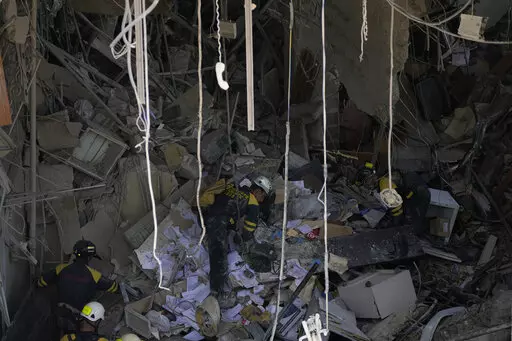 Rescuers search for survivors at the site of Friday's deadly explosion that destroyed the five-star Hotel Saratoga, in Havana, Cuba, Saturday, May 7, 2022. (AP Photo/Ramon Espinosa)