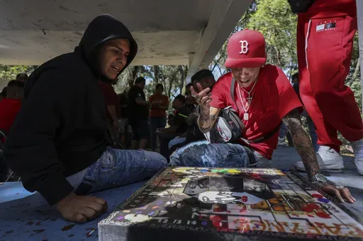 People play poleana, a board game invented in prison, before a tournament in Mexico City, Sunday, Nov. 17, 2024. (AP Photo/Ginnette Riquelme)