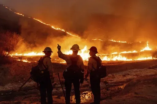 Fire crews battle the Kenneth Fire in the West Hills section of Los Angeles, Jan. 9, 2025. (AP Photo/Ethan Swope, File)