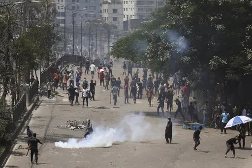 Students clash with riot police during a protest against a quota system for government jobs, in Dhaka, Bangladesh, Thursday, July 18, 2024. (AP Photo/Rajib Dhar)