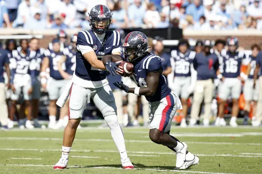 Mississippi quarterback Jaxson Dart (2) hands off the ball to running back Ulysses Bentley IV (24) during the first half of an NCAA college football game against Mississippi, Saturday, Oct. 26, 2024, in Oxford, Miss. (AP Photo/Sarah Warnock)