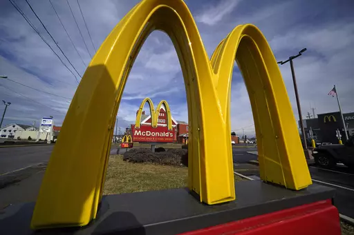 McDonald's restaurant signs are shown in in East Palestine, Ohio, Feb. 9, 2023. Krispy Kreme stock jumped Tuesday, March 26, 2024, after it announced a deal where McDonald’s restaurants will sell its doughnuts across the country.(AP Photo/Gene J. Puskar, File)