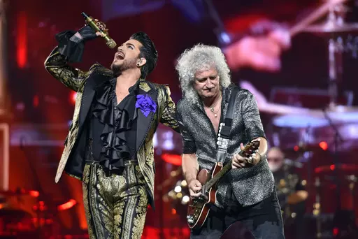 Adam Lambert, left, and Brian May of Queen + Adam Lambert perform in Chicago on Aug. 9, 2019. The band is hitting the road this fall for a North American expansion of their Rhapsody Tour. The tour will make 14 stops throughout the U.S. and Canada, including shows in New York, Boston, Toronto, Chicago, Nashville and Dallas, before closing out at Los Angeles in November. (Photo by Rob Grabowski/Invision/AP, File)
