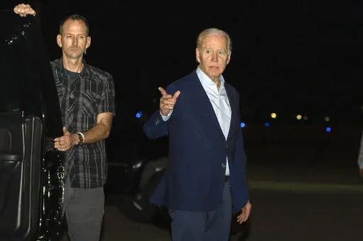 President Joe Biden arrives at Henry E. Rohlsen Airport, in St. Croix, U.S. Virgin Islands, late Tuesday, Dec. 27, 2022. Biden on Thursday signed a $1.7 trillion spending bill that will keep the federal government operating through the end of the federal budget year in September 2023, and provide tens of billions of dollars in new aid to Ukraine for its fight against the Russian military. (AP Photo/Manuel Balce Ceneta, File)
