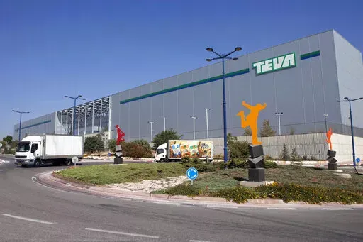 FILE - Trucks drive in front of Teva Pharmaceutical Logistic Center in the town of Shoam, Israel, Oct. 16, 2013. A jury held Teva Pharmaceuticals responsible, Thursday, Dec. 30, 2021, for contributing to the opioid crisis, delivering a verdict in a sweeping lawsuit filed by New York state, the state attorney general said. (AP Photo/Dan Balilty, File)