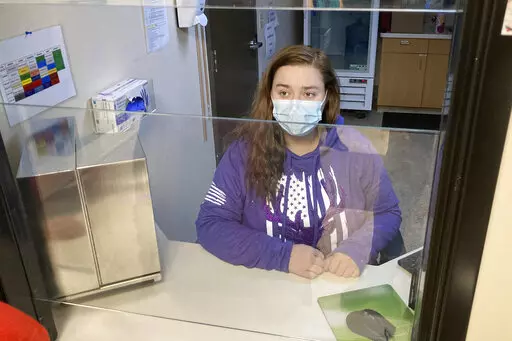 Vanessa Caudel, a nurse, sits at her work station in the Great Circle treatment center where she provides doses of methadone, which can relieve the "dope sick" symptoms a person in opioid withdrawal experiences in Salem, Ore., on Feb. 24, 2022. The center gets funding from Oregon's pioneering drug decriminalization law and illustrates an aspect of the new system, one year after it took effect. (AP Photo/Andrew Selsky)