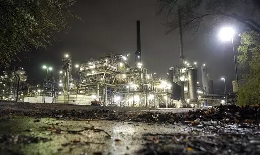 A refinery is illuminated in Gelsenkirchen, Germany, Tuesday evening, April 5, 2022. European governments were poised to ban on Russian coal imports despite the near-certainty of higher utility bills and inflation. But the  limited energy sanction only underlined inability to agree on a much more sweeping ban on oil and gas that would hit Russia much harder but risk inflation and recession at home. (AP Photo/Martin Meissner, File)