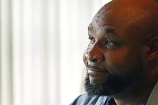 Timothy Norris, a licensed mental health counselor and owner of Mom's Dream Kitchen in Jackson, Miss., speaks during an interview Feb. 14, 2023. Random gunfire, repeated break-ins and an unreliable city water system are constant challenges for the soul food restaurant his mother opened 35 years ago in Mississippi's capital city. (AP Photo/Rogelio V. Solis)