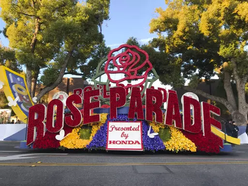 FILE - In this Jan. 1, 2020, file photo, a 2020 Rose Parade float is seen at the start of the route at the 131st Rose Parade in Pasadena, Calif. The Rose Parade and Rose Bowl college football game between Ohio State and Utah were set to go forward on New Year's Day despite surging cases of COVID-19, which forced the cancelation of the 2021 parade. (AP Photo/Michael Owen Baker, File)