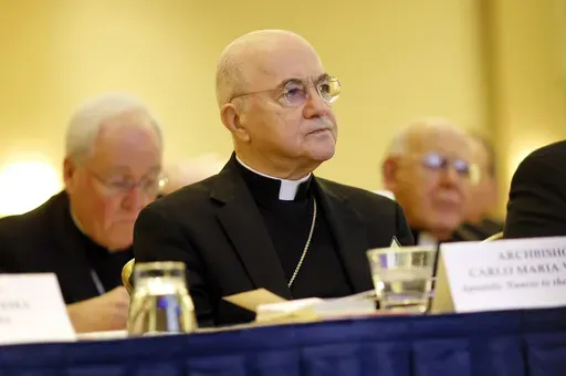 Archbishop Carlo Maria Vigano, Apostolic Nuncio to the U.S., listens to remarks at the U.S. Conference of Catholic Bishops' annual fall meeting in Baltimore, Nov. 16, 2015. The Vatican has excommunicated its former ambassador to the U.S., Archbishop Carlo Maria Viganò, after finding him guilty of schism, an inevitable end for the firebrand conservative who became one of Pope Francis' most ardent critics. (AP Photo/Patrick Semansky, File)