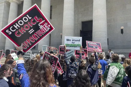 Students and parents rally at the Ohio Statehouse in support of possible changes that would increase eligibility for taxpayer-funded school vouchers to K-12 students statewide, May 17, 2023, in Columbus, Ohio. National Republicans are poised to support “universal school choice” as part of the policy platform they adopt at the 2024 Republican National Convention, which starts next week on Monday, July 15, 2024. (AP Photo/Samantha Hendrickson, File)