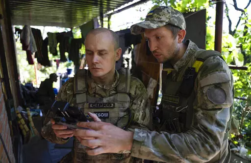 Ukrainian servicemen correcting artillery fire by drone at the frontline near Kharkiv, Ukraine, on Saturday, July 2, 2022. Never in the history of warfare have drones been used as intensively as in Ukraine, where they often play an outsized role in who lives and dies. Russians and Ukrainians alike depend heavily on unmanned aerial vehicles to pinpoint enemy positions and guide their hellish artillery strikes. (AP Photo/Evgeniy Maloletka, File)