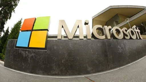 This July 3, 2014, file photo, shows the Microsoft Corp. logo outside the Microsoft Visitor Center in Redmond, Wash. Microsoft is cutting 10,000 workers, almost 5% of its workforce, in response to “macroeconomic conditions and changing customer priorities.”The company said in a regulatory filing Wednesday, Jan. 18, 2023 that had just notified employees of the layoffs, some of which begin immediately.The company said it will also be making changes to its hardware portfolio and consolidating i