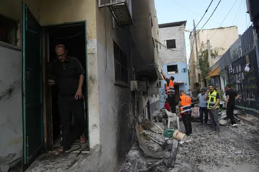 Palestinians municipality workers check a damaged house following an Israeli military operation in the West Bank refugee camp of Al-Faraa, Thursday, Aug. 29, 2024. (AP Photo/Nasser Nasser)
