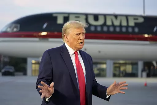 Former President Donald Trump speaks with reporters before departure from Hartsfield-Jackson Atlanta International Airport, Aug. 24, 2023, in Atlanta. A liberal group has filed a lawsuit to bar Trump from the primary ballot in Colorado. The lawsuit contends Trump is ineligible to run for the White House again under a rarely used clause in the U.S. Constitution aimed at candidates who have supported an “insurrection.” (AP Photo/Alex Brandon, File)