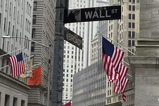 American flags hang from the front the New York Stock Exchange, right, on April 11, 2024 in New York. Global shares are trading higher on Friday, May 10, 2024, after a rally on Wall Street that pulled the S&P 500 back within 1% of its record. (AP Photo/Peter Morgan, File)