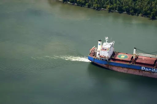 In this aerial photo, sediment and mixed river water is seen as a tanker ship moves upriver, Sept. 26, 2023, in Plaquemines Parish, La. Salt water from the Gulf of Mexico has caused problems for water systems in Plaquemines Parish. Fears that it would reach New Orleans’ water intakes have abated amid improved forecasts, but officials in the area say the threat could return in years to come as climate change, sea level rise and dredging of the river for commercial traffic all could contribute t