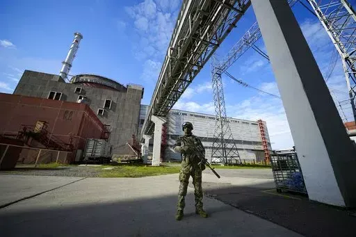 A Russian serviceman guards in an area of the Zaporizhzhia Nuclear Power Station in territory under Russian military control, southeastern Ukraine, Sunday, May 1, 2022. Inspectors from the International Atomic Energy Agency visited the sprawling plant in southern Ukraine on Thursday, Sept. 1, 2022 The IAEA’s Director General Rafael Mariano Grossi highlighted the risks they had to deploy a team in the area amidst the war. (AP Photo, File)