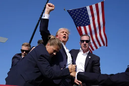 Republican presidential candidate former President Donald Trump is surrounded by U.S. Secret Service agents at a campaign rally, July 13, 2024, in Butler, Pa. (AP Photo/Evan Vucci, File)