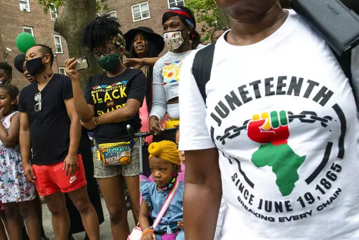 People attend Juneteenth celebrations in the Harlem neighborhood of New York, on June 19, 2021. Recognition of Juneteenth, the effective end of slavery in the U.S., gained traction after the police killing of George Floyd in 2020. But after an initial burst of action, the movement to have it recognized as an official holiday in the states has largely stalled. (AP Photo/Eduardo Munoz Alvarez, File)