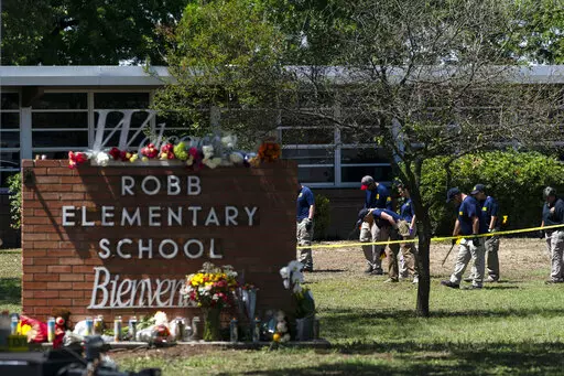 Investigators search for evidences outside Robb Elementary School in Uvalde, Texas, May 25, 2022, after an 18-year-old gunman killed 19 students and two teachers. The district’s superintendent said Wednesday, June 22, that Chief Pete Arredondo, the Uvalde school district’s police chief,  has been put on leave following allegations that he erred in his response to the mass shooting.  (AP Photo/Jae C. Hong, File)