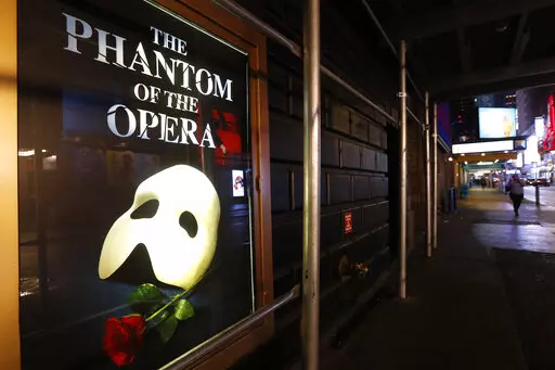 A poster advertising "The Phantom of the Opera," is displayed on the shuttered Majestic Theatre in New York, March 12, 2020. Broadway's longest-running show will play its final performance on Broadway on Feb. 18, 2023, a spokesperson told The Associated Press on Friday, Sept. 16, 2022. The closing will come less than a month after its 35th anniversary. (AP Photo/Kathy Willens, File)