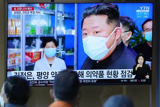 People watch a TV screen showing a news program reporting with an image of North Korean leader Kim Jong Un, at a train station in Seoul, South Korea on May 16, 2022. As an illness suspected to be COVID-19 sickens hundreds of thousands of his people, Kim stands at a critical crossroad. Does he swallow his pride and accept help or does he go it alone even though a huge number of fatalities could undermine his leadership? (AP Photo/Lee Jin-man, File)