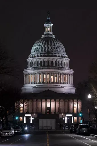 The Capitol is seen Wednesday evening as the House of Representatives works to approve the Respect for Marriage Act, a bill already passed in the Senate to codify both interracial and same-gender marriage, in Washington, Dec. 7, 2022. (AP Photo/J. Scott Applewhite)