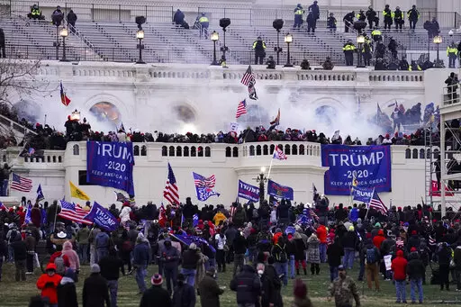 Violent rioters, loyal to President Donald Trump, storm the Capitol in Washington, Jan. 6, 2021. Opening statements are expected to begin Monday, Dec. 12, 2022, in the second seditious conspiracy trial against members of the far-right Oath Keepers extremist group charged in the Jan. 6, Capitol attack. The defendants facing jurors in the latest trial are Joseph Hackett, Roberto Minuta, David Moerschel, and Edward Vallejo. (AP Photo/John Minchillo, File)