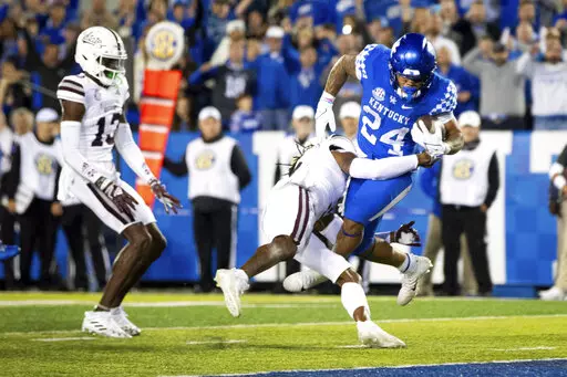 Kentucky running back Chris Rodriguez Jr. (24) is tackled into the end zone for a touchdown by Mississippi State defensive end Jordan Davis during the second half of an NCAA college football game in Lexington, Ky., Saturday, Oct. 15, 2022. (AP Photo/Michael Clubb)