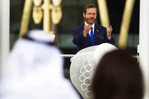 Israeli President Isaac Herzog speaks at Expo 2020 in Dubai, United Arab Emirates, Monday, Jan. 31, 2022. The UAE intercepted a ballistic missile fired by Yemen's Houthi rebels early Monday as the Israeli president visited the country, authorities said, the third such attack in recent weeks. (AP Photo/Jon Gambrell)