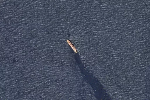 In this satellite image provided by Planet Labs, the Belize-flagged bulk carrier Rubymar is seen in the southern Red Sea near the Bay el-Mandeb Strait leaking oil after an attack by Yemen's Houthi rebels Tuesday, Feb. 20, 2024. Despite a month of U.S.-led airstrikes, Yemen's Iran-backed Houthi rebels remain capable of launching significant attacks. This week, they seriously damaged a ship in a crucial strait and apparently downed an American drone worth tens of millions of dollars. (Planet Labs 