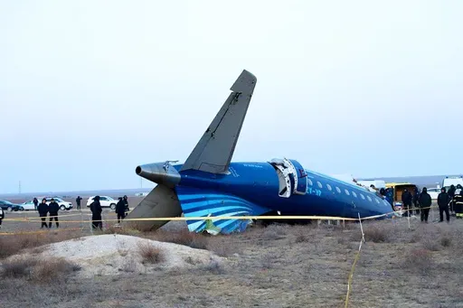 In this photo taken from a video released by the administration of Mangystau region, a part of Azerbaijan Airlines' Embraer 190 lies on the ground near the airport of Aktau, Kazakhstan, on Thursday, Dec. 26, 2024. (The Administration of Mangystau Region via AP)
