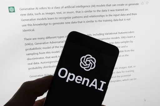 The OpenAI logo is seen on a mobile phone in front of a computer screen displaying output from ChatGPT, on March 21, 2023, in Boston. The Italian government’s privacy watchdog said Friday March 31, 2023 that it is temporarily blocking the artificial intelligence software ChatGPT in the wake of a data breach. (AP Photo/Michael Dwyer, File)