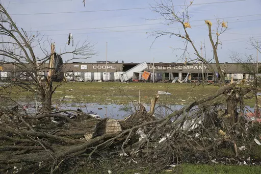 The broken and damaged trees along U.S. Hwy 45 South are covered with metal and other materials that were ripped off the nearby Cooper Tire and Rubber Company, on April 1, 2023, in Tupelo, Miss. Production at the large north Mississippi tire plant has ground to a halt in the wake of a damaging tornado, halting operations at the second-largest production facility for Goodyear’s North American network. (Thomas Wells/The Northeast Mississippi Daily Journal via AP, File)