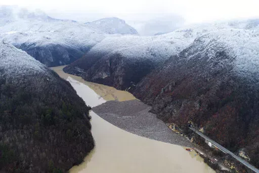 Aerial view of waste floating in the Drina river near Visegrad, Bosnia, Friday, Jan. 20, 2023. Tons of waste dumped in poorly regulated riverside landfills or directly into the rivers across three Western Balkan countries end up accumulating during high water season in winter and spring, behind a trash barrier in the Drina River in eastern Bosnia. (AP Photo/Armin Durgut)