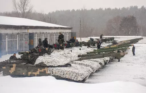 Ukrainian soldiers examine their tanks at a military unit close to Kharkiv, Ukraine, Monday, Jan. 31, 2022. Russia's foreign minister claims that NATO wants to pull Ukraine into the alliance, amid escalating tensions over NATO expansion and fears that Russia is preparing to invade Ukraine. (AP Photo/Andrew Marienko)