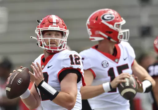 Georgia quarterbacks Brock Vandagriff (12) and Carson Beck (15) warm up before the G - Day spring football game at Sanford Stadium, Saturday, April 15, 2023, in Athens, Ga. Beck has attempted 58 passes over the past three seasons. Third-year player Brock Vandagriff was a five-star recruit. (Hyosub Shin/Atlanta Journal-Constitution via AP, File)