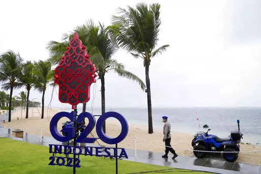 A police officer walks past a G20 sign in Nusa Dua, Bali, Indonesia, Thursday, July 7, 2022. Foreign ministers from the Group of 20 leading rich and developing nations are gathering in Indonesia's resort island of Bali for talks bound to be dominated by the conflict in Ukraine despite an agenda focused on global cooperation and food and energy security. (AP Photo/Dita Alangkara)