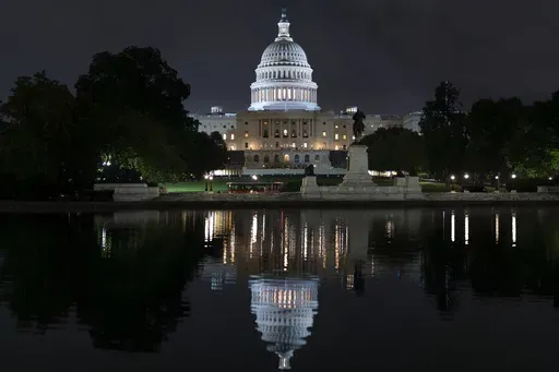 The Capitol is seen in the reflecting pool as lawmakers work into the evening, in Washington, Monday, Sept. 23, 2024. (AP Photo/J. Scott Applewhite, File)