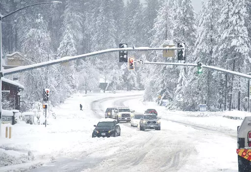 A vehicle is stuck in the snow along Brunswick Road and Sutton Way Monday morning, Dec. 27, 2021, in Grass Valley, Calif. (Elias Funez/The Union via AP)