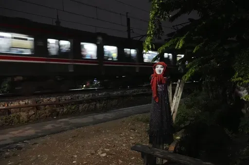 An effigy is seen near a railway track where two commuter trains collided in 1987, killing 139 people, in Bintaro, Indonesia, Friday, Oct. 25, 2024. (AP Photo/Tatan Syuflana)