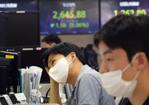 A currency trader watches monitors at the foreign exchange dealing room of the KEB Hana Bank headquarters in Seoul, South Korea, Tuesday, May 24, 2022. Asian shares were mostly lower on Tuesday as worries over inflation tempered optimism over President Joe Biden’s remark that he was considering reducing U.S. tariffs on Chinese imports. (AP Photo/Ahn Young-joon)