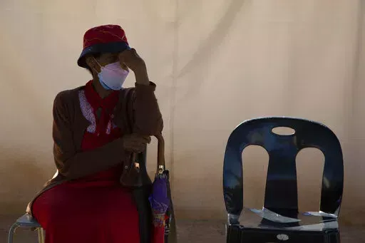 A woman waits in a queue to be screened for COVID-19 at a testing centre in Soweto, South Africa, Wednesday, May 11, 2022. Health experts in South Africa say the country is experiencing a surge of new COVID-19 cases driven by two omicron sub-variants. Professor Marta Nunes, a researcher at Vaccine and Infectious Diseases Analytics at Chris Hani Baragwanath Hospital in Soweto said that for about three weeks the country has seen increasing numbers of new cases and somewhat higher hospitalizations,