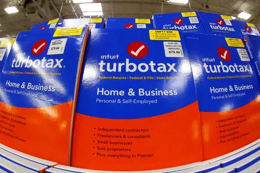 This Thursday, Feb. 22, 2018 photo shows a display of TurboTax software in a Sam's Club in Pittsburgh.  Under the terms of a settlement signed by the attorneys general of all 50 states, Mountain View, California-based Intuit Inc. will suspend TurboTax’s “free, free, free” ad campaign and pay restitution to nearly 4.4 million taxpayers, New York Attorney General Letitia James said, Wednesday, May 4, 2022.(AP Photo/Gene J. Puskar)