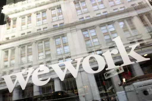 The WeWork logo is seen at one of the company's offices, Jan. 16, 2020, in New York. WeWork has officially emerged from bankruptcy — and appointed a new leadership in the process. (AP Photo/Mark Lennihan, File)