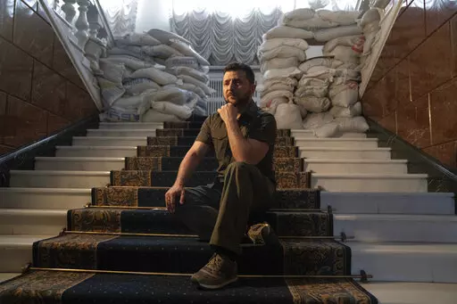 Ukrainian President Volodymyr Zelenskyy speaks during an interview with The Associated Press in his office in Kyiv, Ukraine, Saturday, April 9, 2022. Ukrainian President Volodymyr Zelenskyy says he's committed to pressing for peace despite Russian attacks on civilians that have stunned the world. (AP Photo/Evgeniy Maloletka)