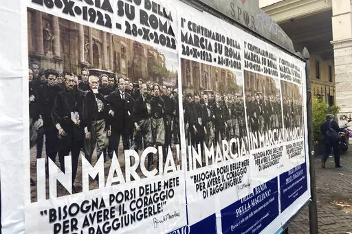 Posters commemorating the 100th anniversary of the March on Rome bearing a picture of Italian Fascist Dictator Benito Mussolini reading: "Marching!" with a quote by Mussolini "you have to set yourself goals to have the courage to reach them" are posted on the Rome's public billboard space, Thursday, Oct. 27, 2022. The posters were later ordered removed by Rome's Mayor Roberto Gualtieri. (AP Photo/Gregorio Borgia)