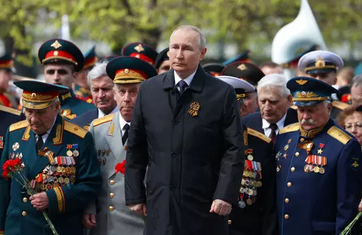 Russian President Vladimir Putin, centre, attends a wreath-laying ceremony at the Tomb of the Unknown Soldier after the military parade marking the 77th anniversary of the end of World War II, in Moscow, Russia, Monday, May 9, 2022. (Anton Novoderezhkin, Sputnik, Kremlin Pool Photo via AP)